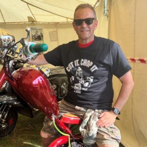 Scooterboy sitting on a red Lambretta chopper wearing a black scooter chopper t-shirt