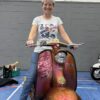 Scooterist on a pink and gold Lambretta Series 1 scooter wearing a 2024 National Rallies shirt
